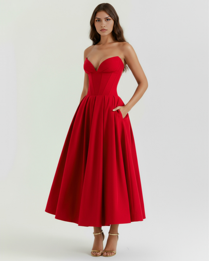 Red strapless dress worn by a model on a white background