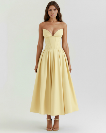 Woman wearing a strapless yellow dress on a white background